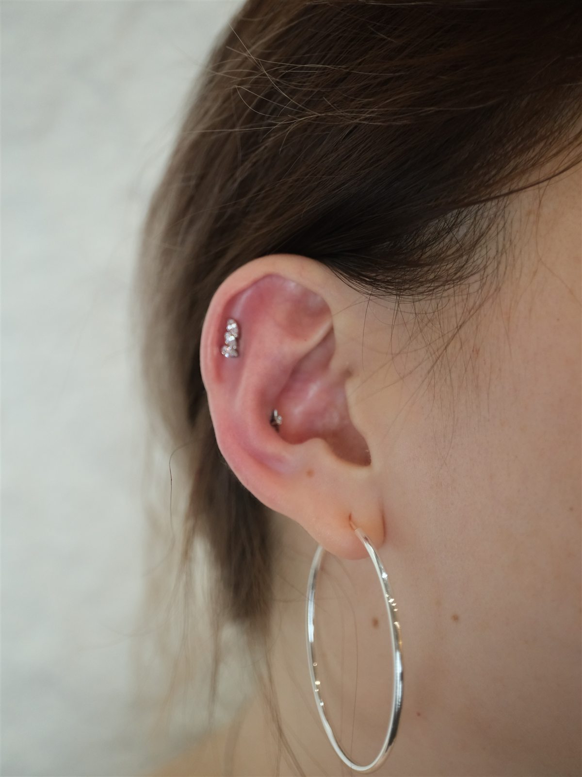 Minimal curated ear piercing completed at Urban Ink