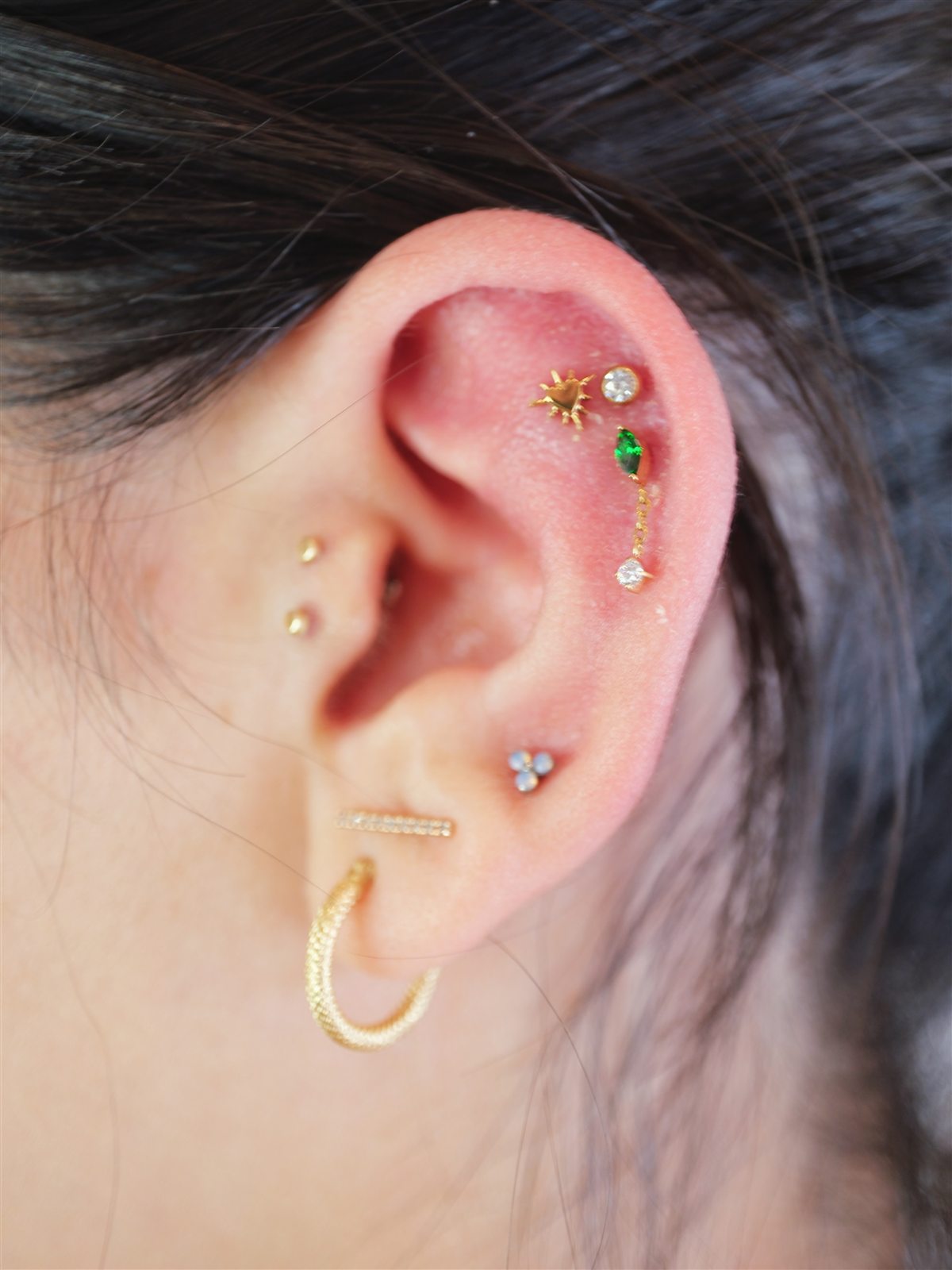 Gold and green curated ear piercing completed at Urban Ink