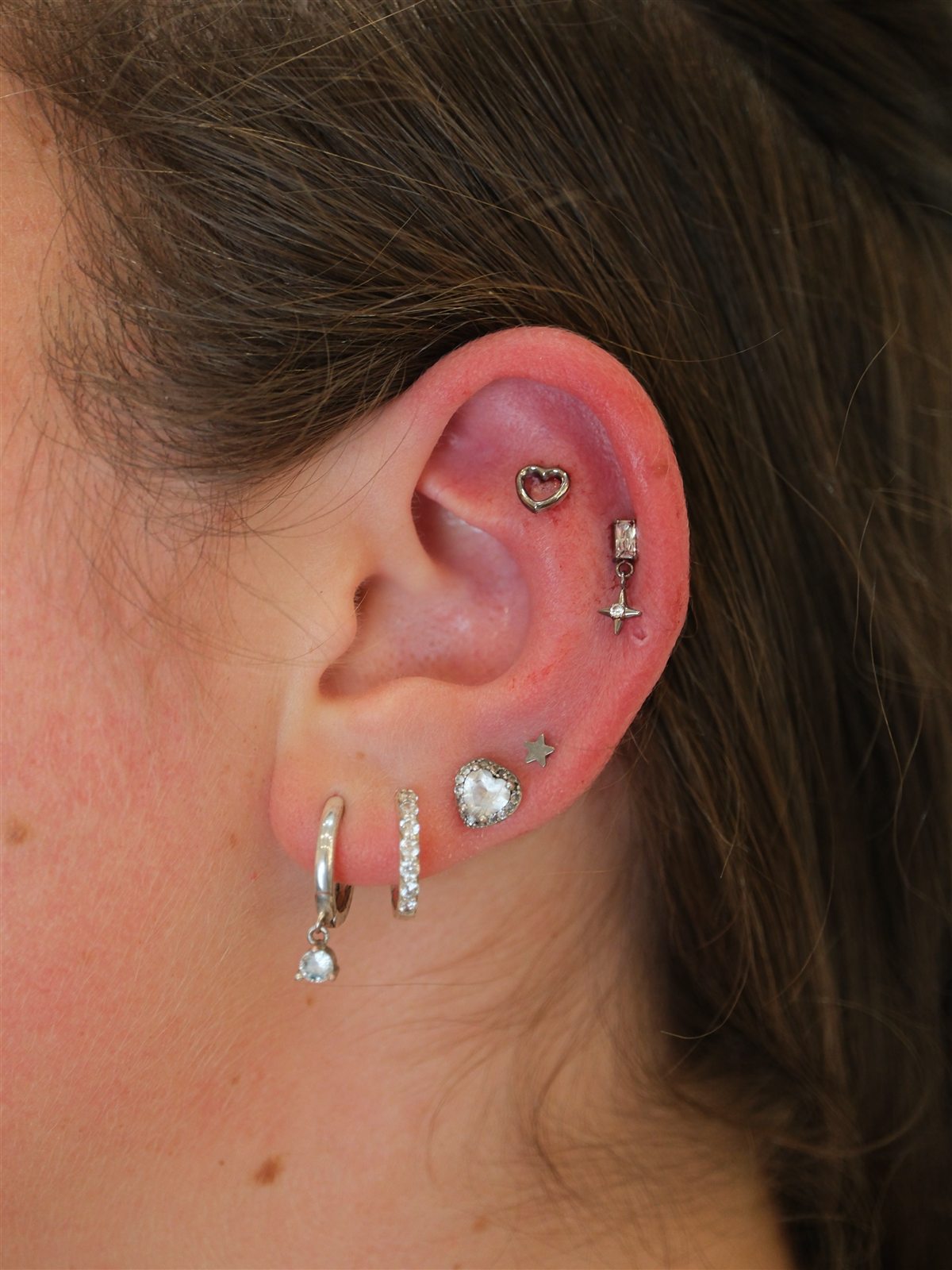 Silver heart and star curated ear piercing completed at Urban Ink