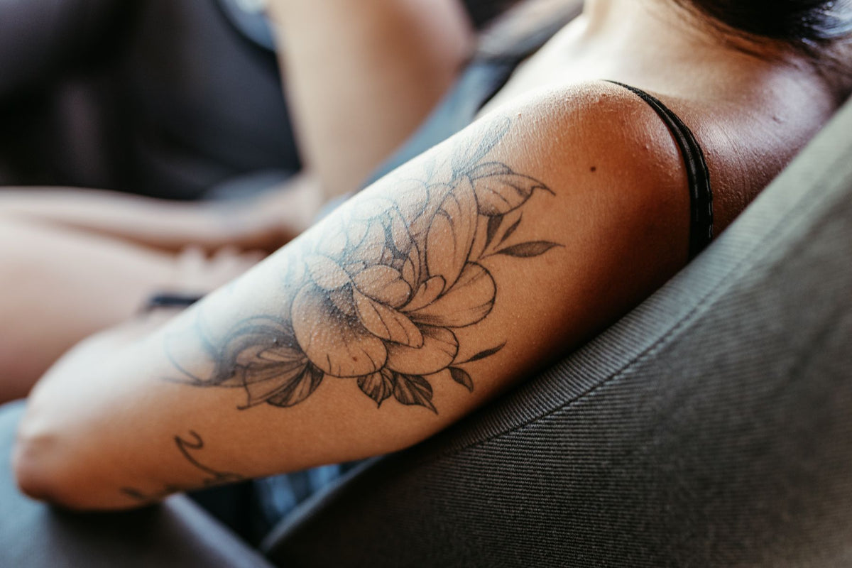 Small floral arm tattoo inspiration for meaningful Los Angeles tattoo ideas