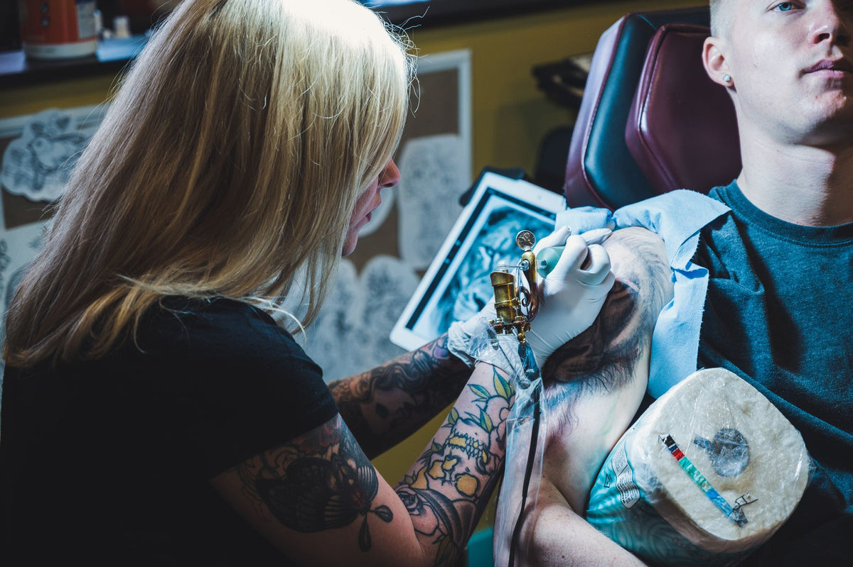Tattoo artist working carefully during a first tattoo appointment in Los Angeles
