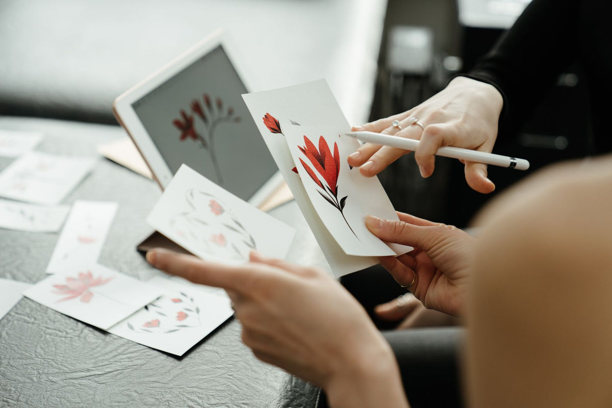 Tattoo consultation with floral sketches for a custom storytelling tattoo design