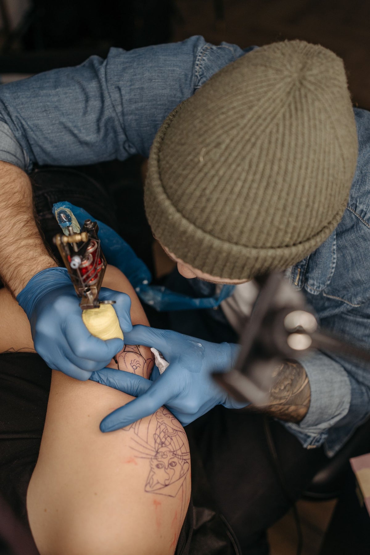 Tattoo artist creating a custom design that represents a personal story