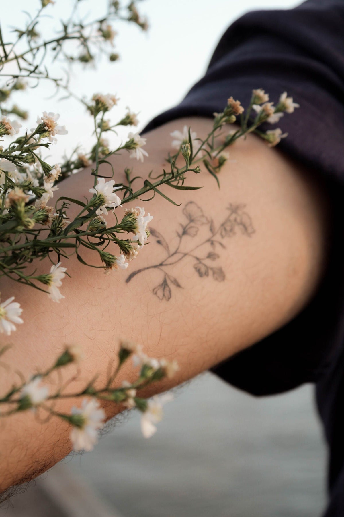 Close-up floral tattoo with white flowers for fine-line and color flower tattoo ideas
