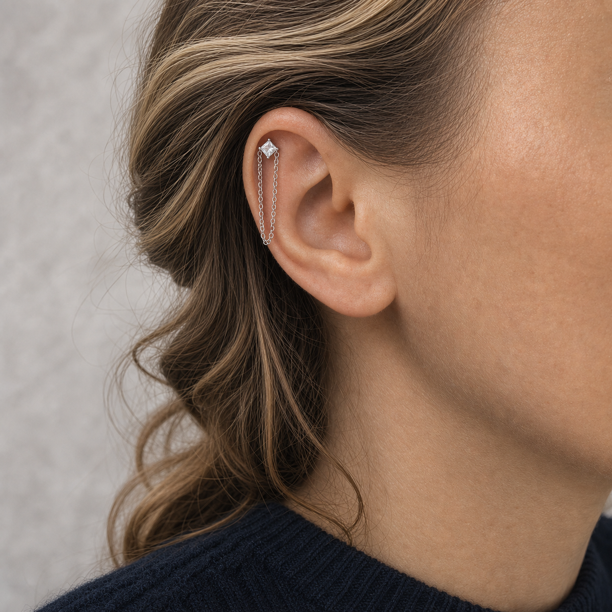 Clear CZ ASTM F136 Titanium Flat Back - Silver, Threadless, 18G, 1.0 x 6+4 mm — wearing view one (P-FB-0101-S01)