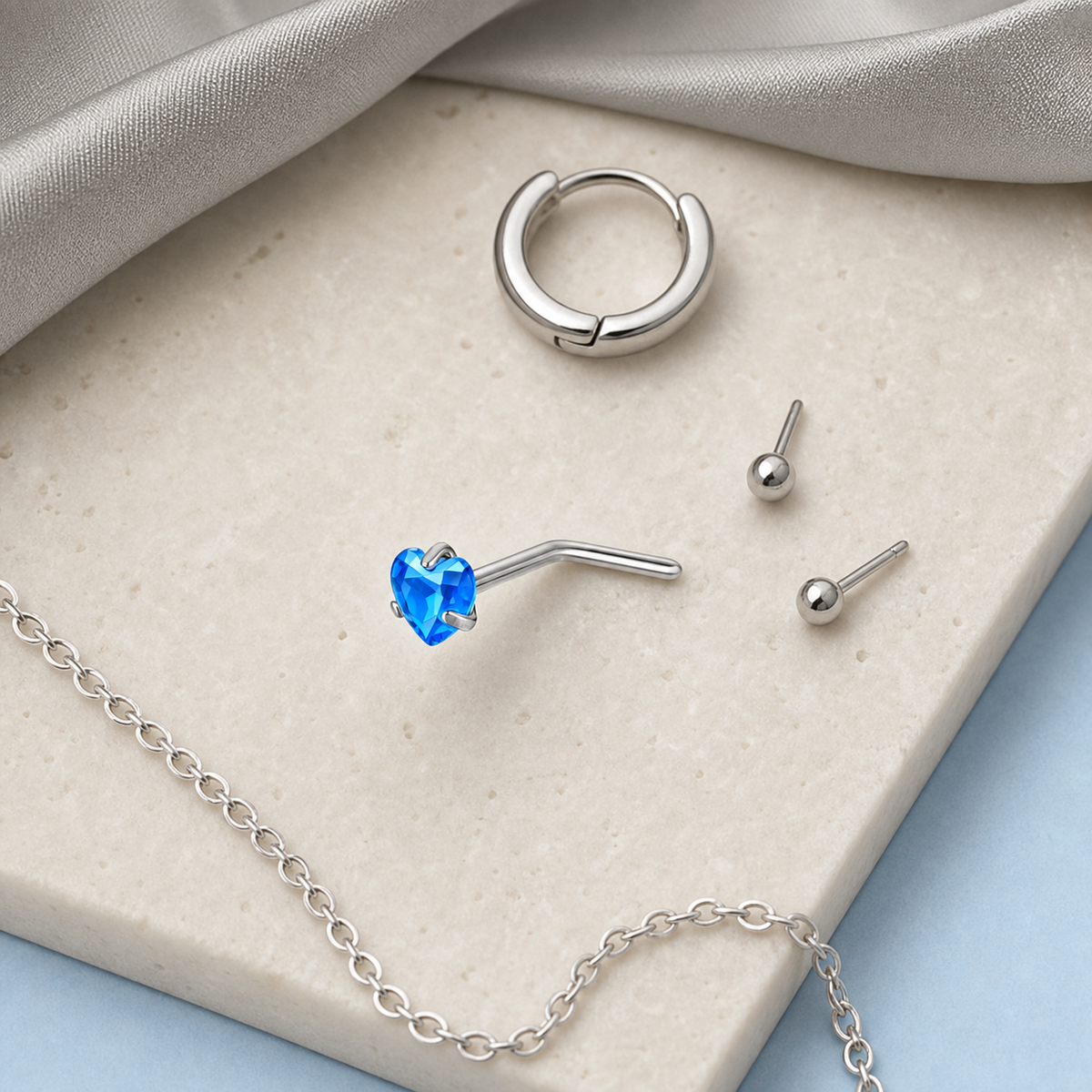 [TOPOSH-ROLE-ORDER-CLEANUP-20260717-BATCH09:TP-NS-L-SIL-20G6-T3-LBL-028:06] Heart Light Blue Titanium L-Bend Nose Stud – Silver | 06_accessory_flatlay