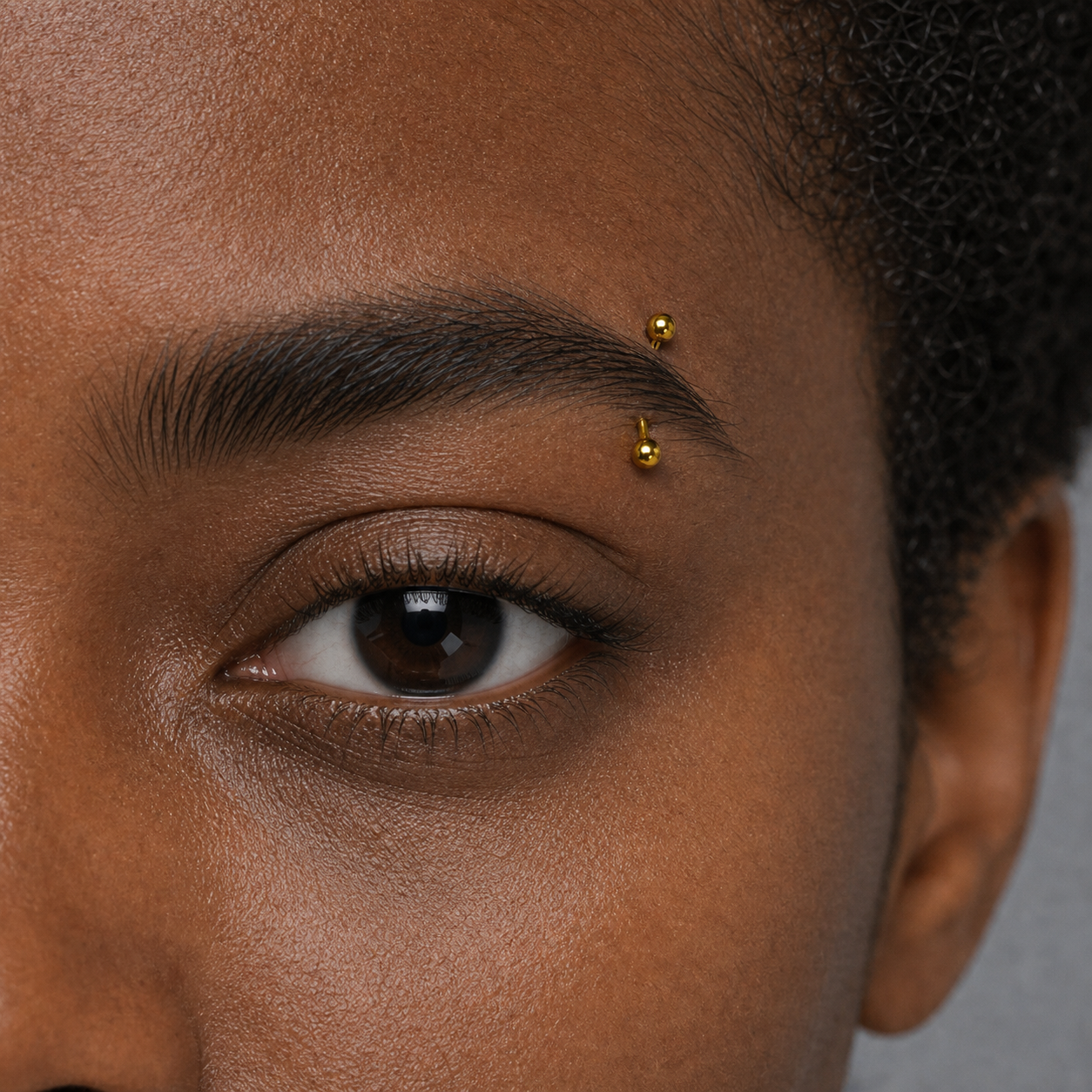 Implant Grade Titanium - Eyebrow Ring - Gold - 16G (1.2 x 8+3 x 3 mm) - model wear view