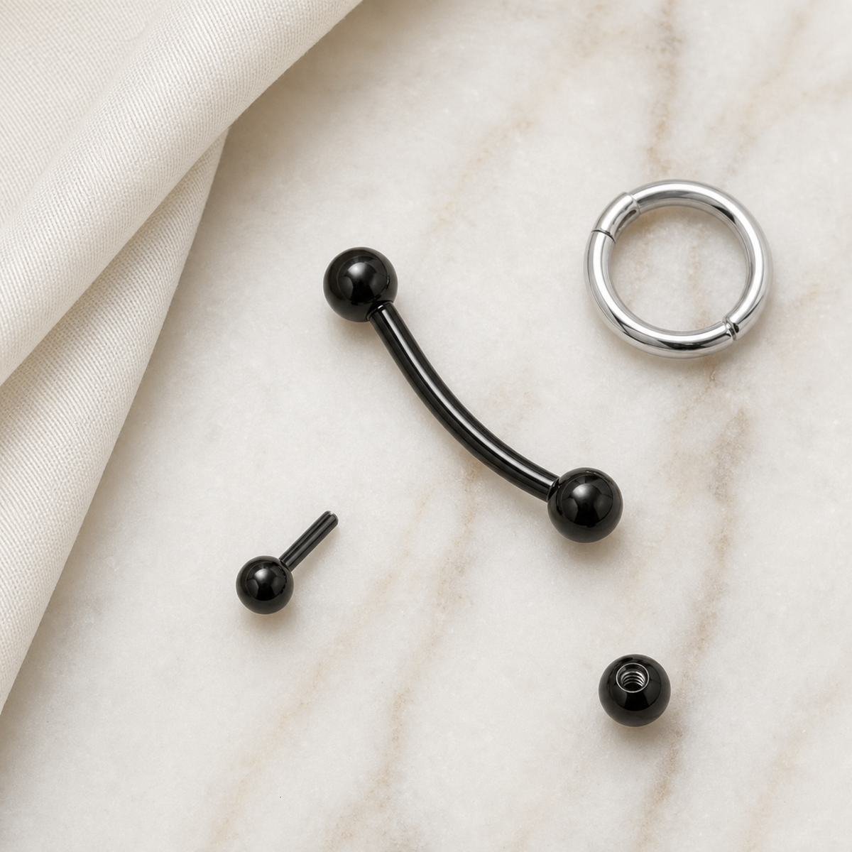 [TOPOSH-ROLE-ORDER-CLEANUP-20260717-BATCH16:TP-EBR-EX-BK-16G10-B3-B3-PLN-565:06] Titanium Eyebrow Barbell – Black, 10+3+3mm | 06_accessory_flatlay